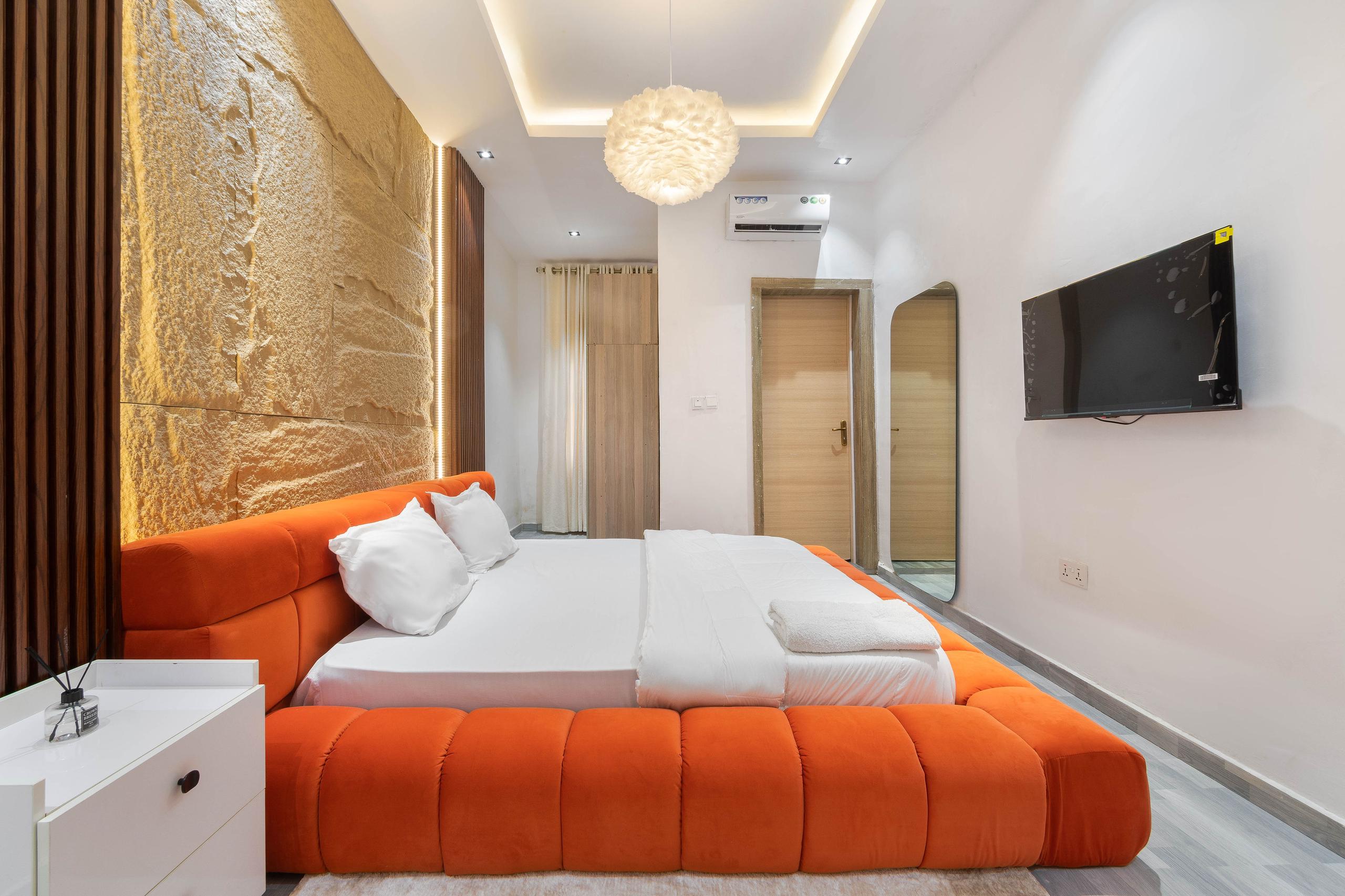Bedroom with Orange Velvet Platform Bed