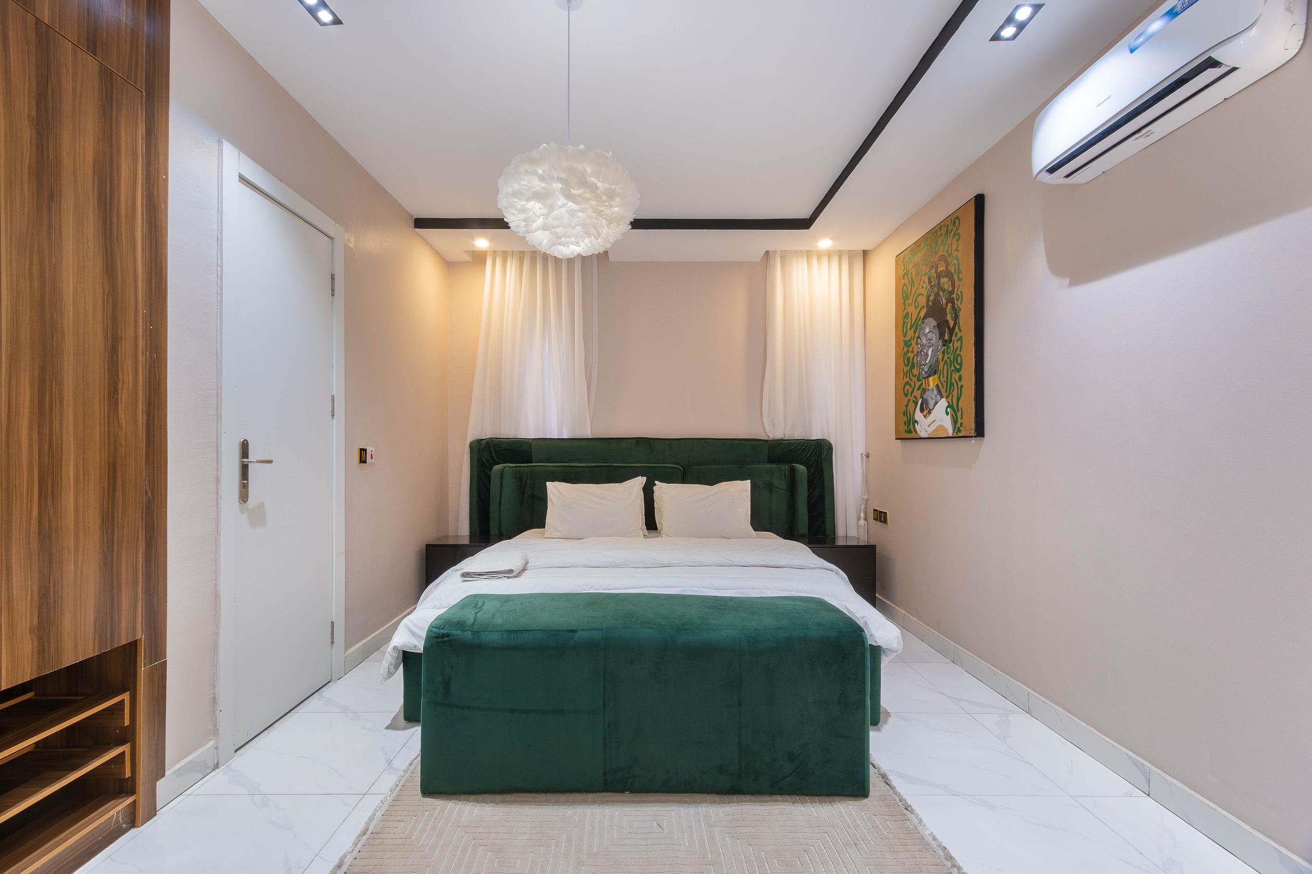 Emerald Bedroom with African-Inspired Art