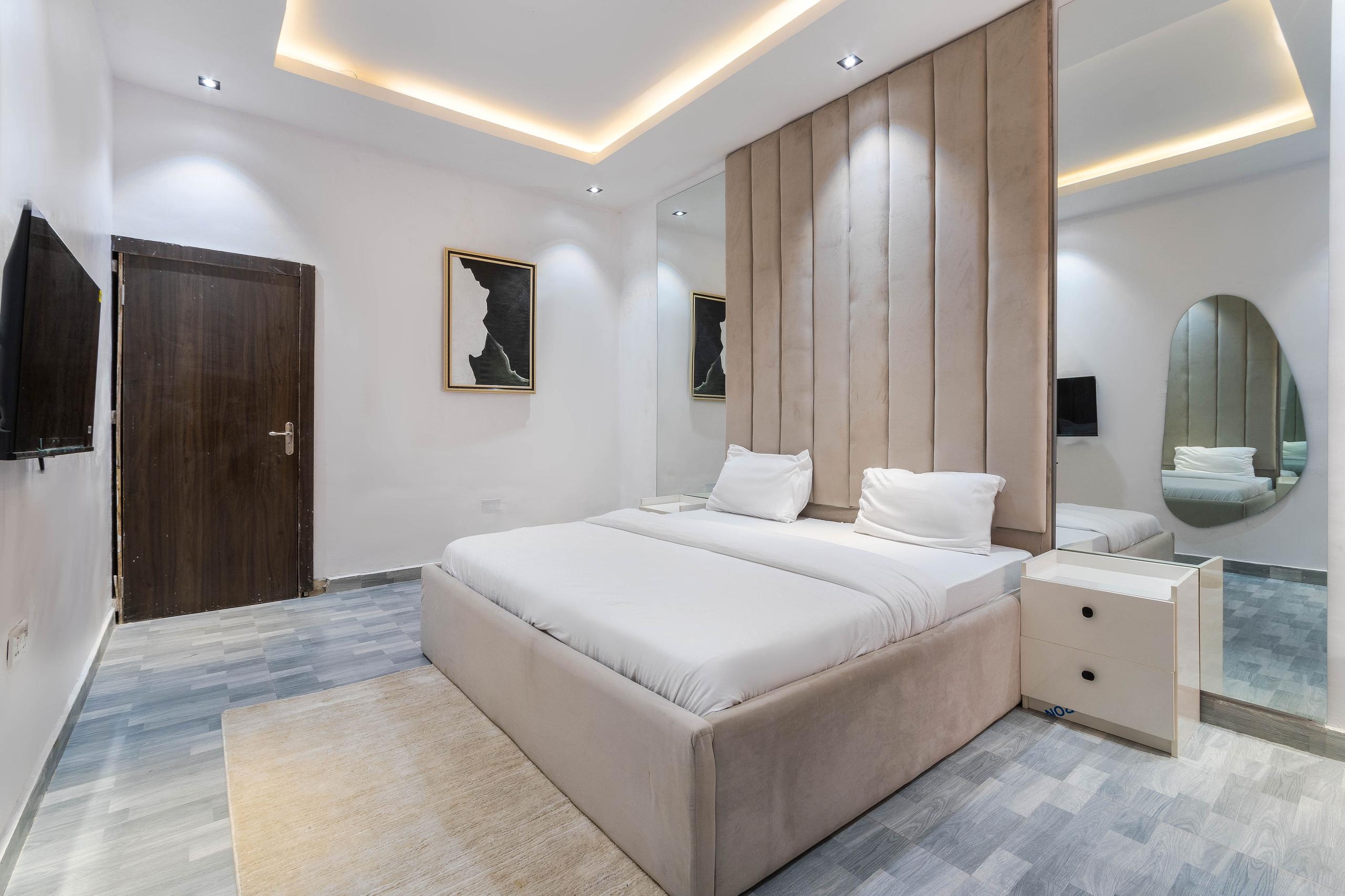 Bedroom with Cove Lighting and Oval Mirror