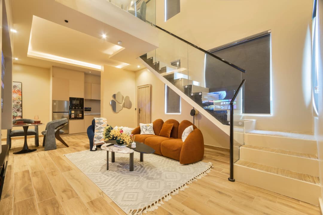 Double-Height Living Space with Glass Staircase
